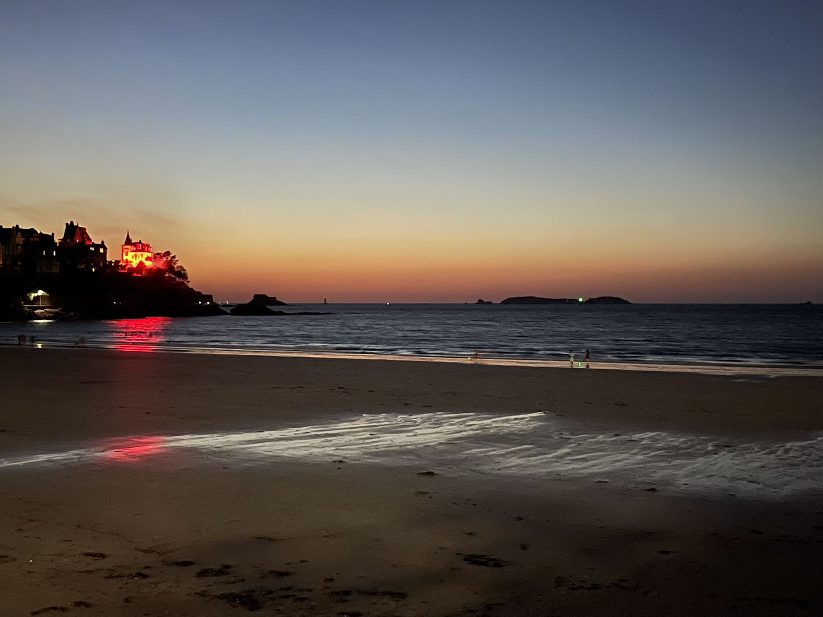 Dusk on Dinard beach, with an illuminated villa